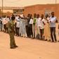 Migrants hold up banners to protest violence against refugees as UN refugee chief Filippo Grandi visits Agadez last June