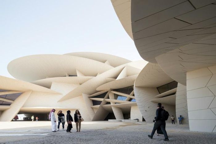 Visitors walk in front of the newly constructed National Museum of Qatar, which opens this week