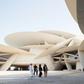 Visitors walk in front of the newly constructed National Museum of Qatar, which opens this week