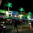 Tourists on Ocean Drive, where students on Spring Break drink bucket-sized discount cocktails