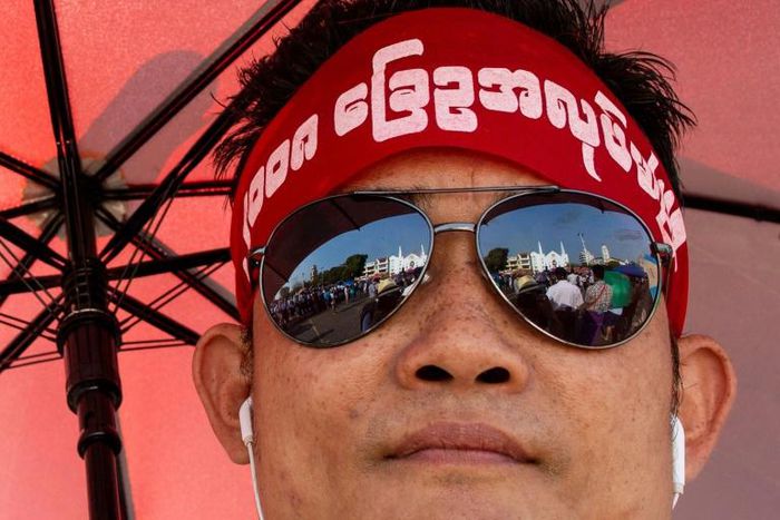 The rally drew hundreds wearing headbands and T-shirts calling for reform of the military-scripted constitution