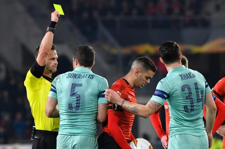 Arsenal's Sokratis Papastathopoulos (wearing no 5) was shown two yellow cards in less than 10 minutes in the first half