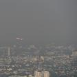 A commercial plane flies over smog-covered Chiang Mai on Tuesday