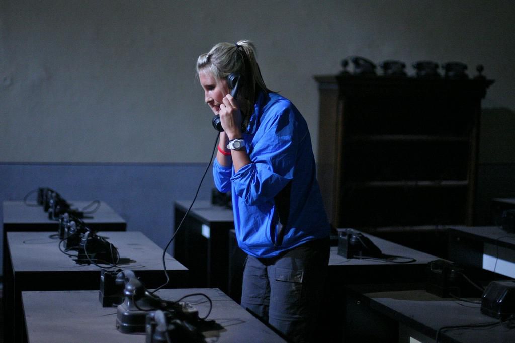 Meghan Rickey performs a Road Block in which one team member must answer phones in search of 5 spoken letters F-R-A-N-Z to unscramble in order to receive their next clue on The Amazing Race season 15.