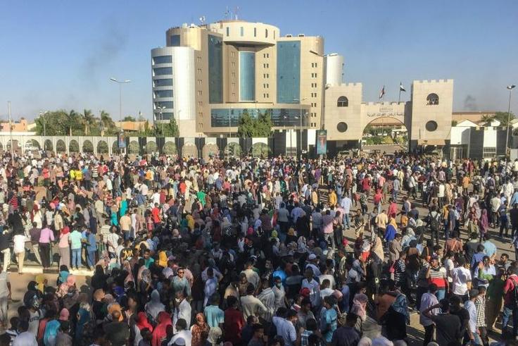 Sudanese protesters shout anti-government slogans outside the military headquarters in the capital Khartoum on April 6, 2019
