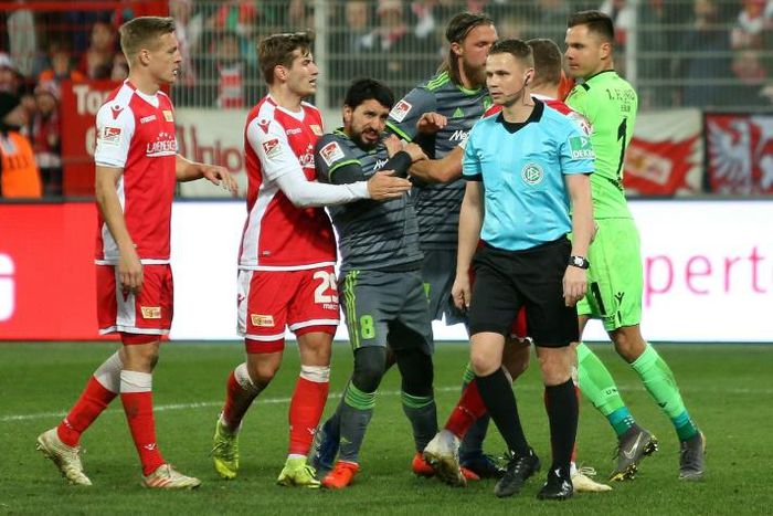 FC Union Berlin players grabbed with Ingolstadt's Almog Cohen after the incident that led a red card for the Israeli midfielder who was then subject to anti-Semitic abuse on Twitter