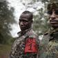 Two brigade leaders from the UPC armed group pose for photographs in the city of Bokolobo, near Bambari on March 16, 2019