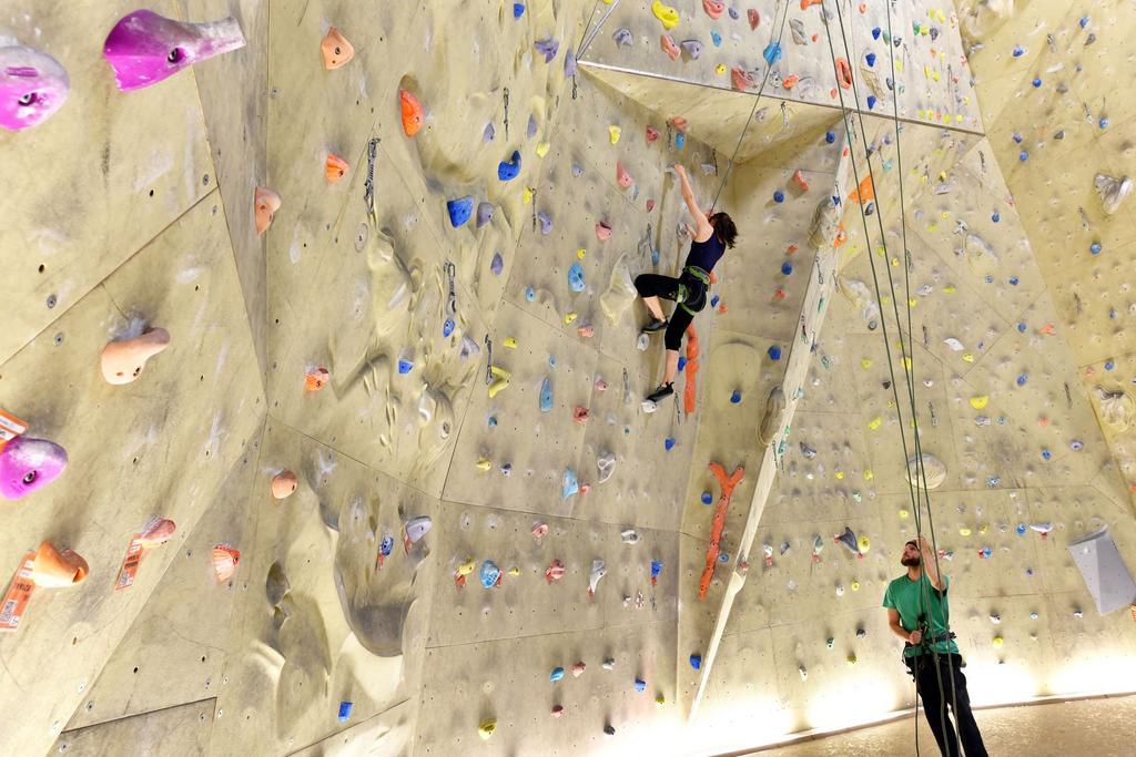 young sporty couple of climbers in a climbing hall