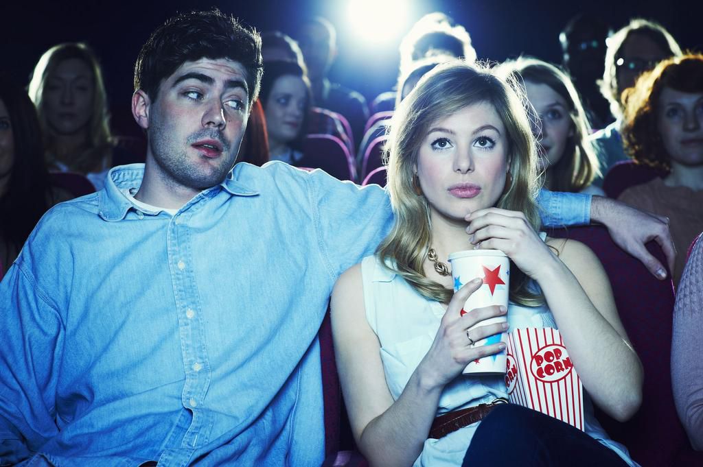 couple enjoying a movie at the cinema