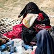 Dorothee Maquere, wife of French jihadist Jean-Michel Clain, sits with four of her five children at a screening area in the eastern Syrian province of Deir Ezzor on March 5, 2019 after fleeing the IS group's holdout of Baghouz