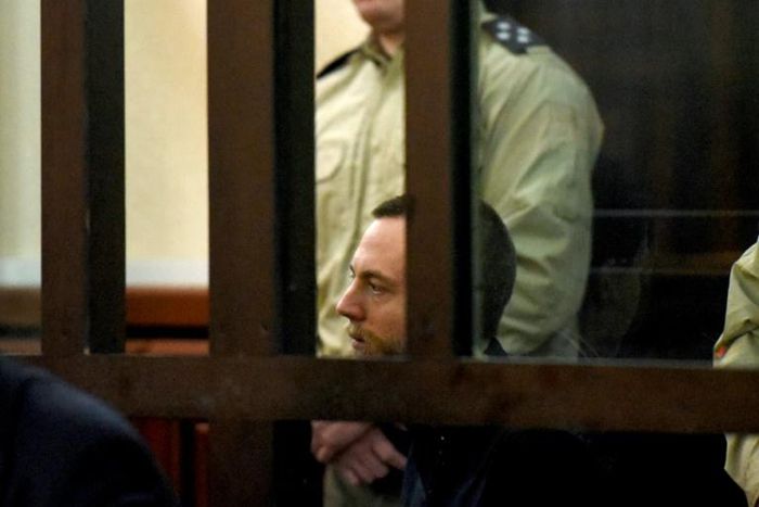 British citizen Jack Shepherd sits inside the defendants' cage during an extradiction hearing at a court in Tbilisi on March 26, 2019