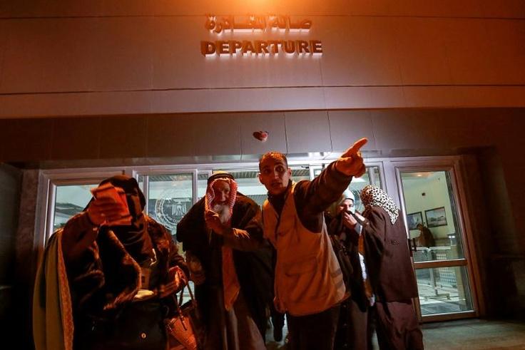 Palestinians get ready to board a bus at the Rafah border between the Gaza Strip and Egypt on March 3, 2019 as they make their way to Saudi Arabia for the Muslim umra pilgrimage