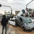 Cars pilled up in a street of the southern Iranian city of Shiraz where at least 11 people were killed and 68 injured in flooding