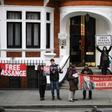 Supporters of WikiLeaks founder Julian Assange display banners and placards as they gather outside the Ecuadorian Embassy in London, where Assange has been living for more than six years and will meet with an independent rights expert