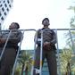 Policemen stand guard outside the Constitutional Court in Bangkok on Thursday ahead of a court ruling on the Thai Raksa Chart party