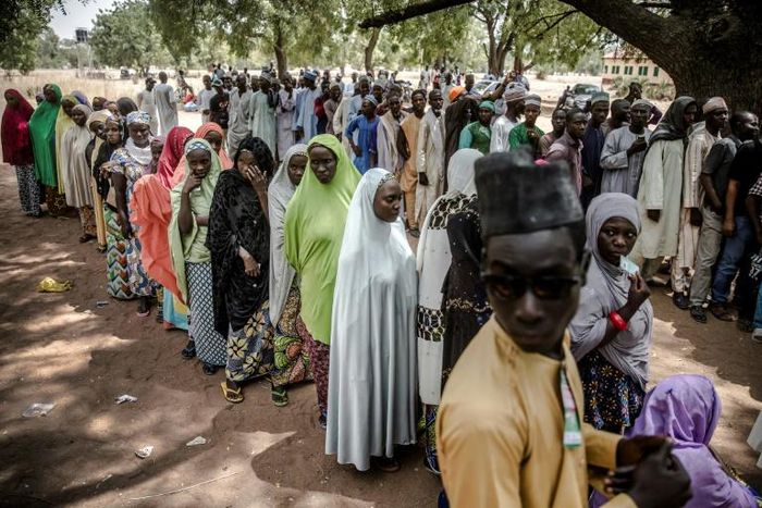 Wait: Voters queue at a polling station in Malkohi refugee camp in Adamawa state -- a facility for people displaced by the Boko Haram jihadist insurgency