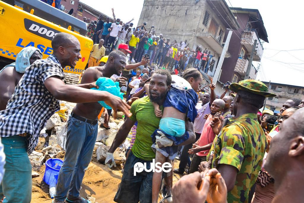 A jubilant crowd cheers as a conscious girl is rescued (Pulse)