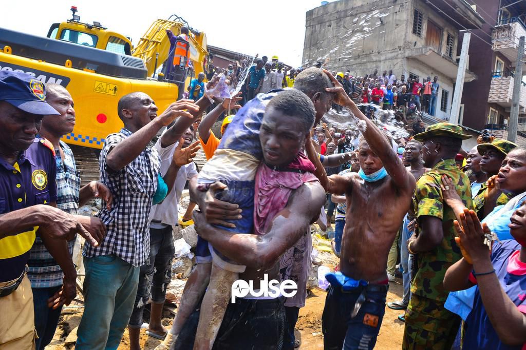 Water is poured on a school child after being rescued (Pulse)