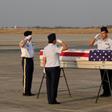 A US military honour guard salutes the flag-draped coffin bearing the recovered remains of suspected American World War II airmen during a repatriation ceremony at the Mandalay International Airport on Tuesday