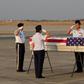 A US military honour guard salutes the flag-draped coffin bearing the recovered remains of suspected American World War II airmen during a repatriation ceremony at the Mandalay International Airport on Tuesday