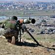 A fighter with the Syrian Democratic Forces (SDF) aims a recoiless gun toward a part of Baghouz where remaining Islamic State (IS) group fighters are holding out in their last position in the countryside of eastern Syria