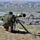 A fighter with the Syrian Democratic Forces (SDF) aims a recoiless gun toward a part of Baghouz where remaining Islamic State (IS) group fighters are holding out in their last position in the countryside of eastern Syria