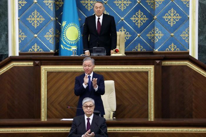 Kazakhstan's new interim president Kassym-Jomart Tokayev (bottom) was sworn, taking over from long-time former president Nursultan Nazarbayev (top)