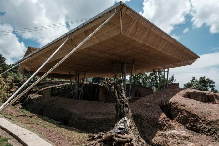 Massive shelters have been erected to protect the ancient stone-carved churches