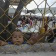 A Honduran boy, pictured in February 2018, looks through a fence from inside a shelter for migrants travelling to the United States in Piedras Negras, Mexico, on the US border