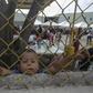 A Honduran boy, pictured in February 2018, looks through a fence from inside a shelter for migrants travelling to the United States in Piedras Negras, Mexico, on the US border