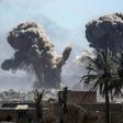 A plume of black smoke rises above the Islamic State group's last redoubt in the village of Baghouz in eastern Syria