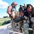 Fighters of the Kurdish-led Syrian Democratic Forces make victory signs as they return from the front after delivering a killer blow to the last vestige of the Islamic State group's caliphate