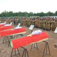 Burkina Faso soldiers in August 2018 pay their respects to soldiers killed when their vehicle struck a roadside bomb in the eastern part of the country