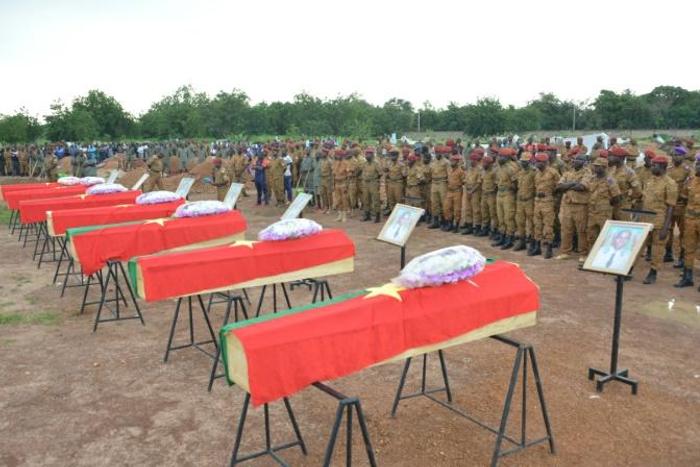 Burkina Faso soldiers in August 2018 pay their respects to soldiers killed when their vehicle struck a roadside bomb in the eastern part of the country