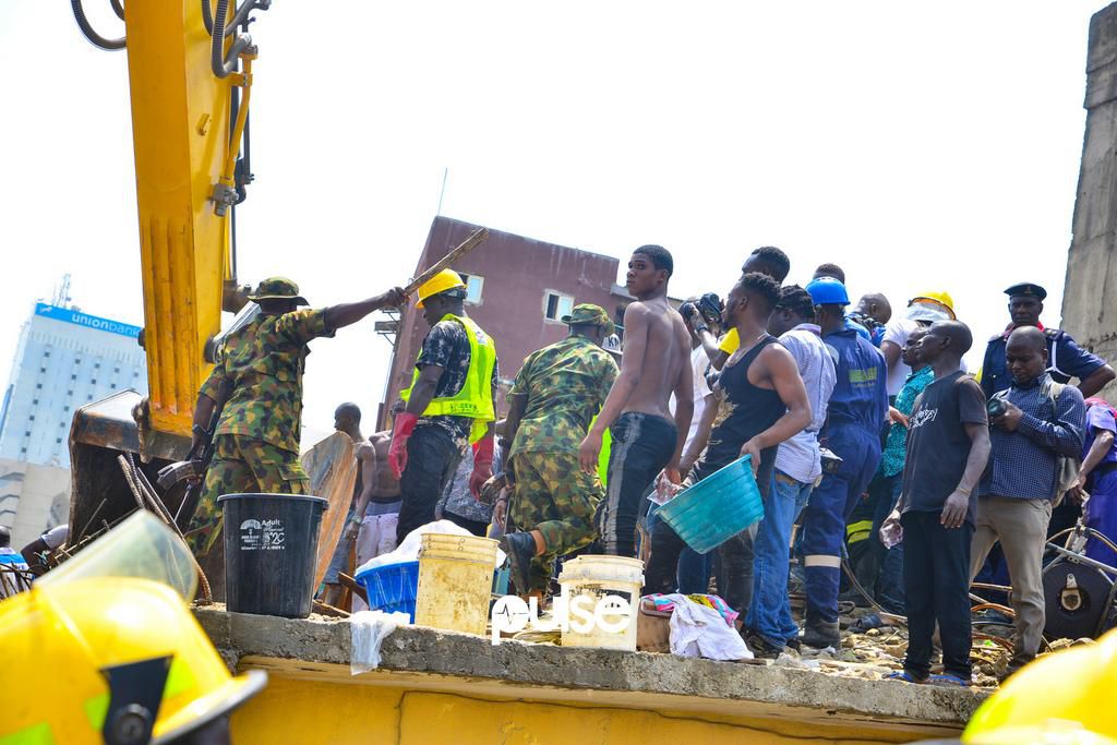 A soldier instructs local residents to step down from the rescue operations (Pulse)