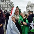 Protesters wear the Algerian national flag in the capital Algiers on March 8, 2019
