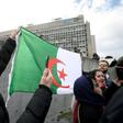 A man holds an Algerian flag in front of the Geneva University Hospitals (HUG) in Geneva where ailing President Abdelaziz Bouteflika is receiving treatment