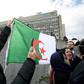 A man holds an Algerian flag in front of the Geneva University Hospitals (HUG) in Geneva where ailing President Abdelaziz Bouteflika is receiving treatment