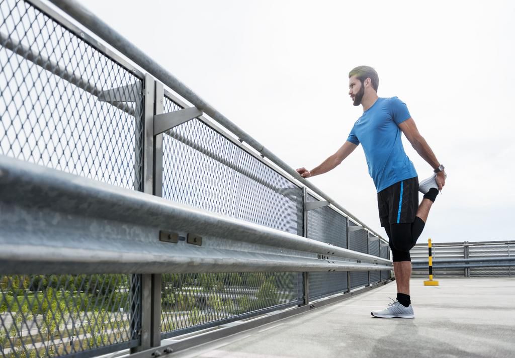 Man stetching on a parking level