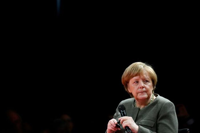 Chancellor Angela Merkel said Germany would lift defence spending but not at the cost of development aid, rejecting US criticism