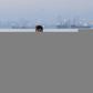 Every weekend, Reymark Cavesirano paddles out across Manila Bay on a makeshift raft of styrofoam to work helping fishermen clean their nets