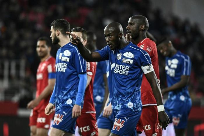 Amiens' defender Prince Gouano points to supporters after hearing racists insults during the French Ligue 1 match