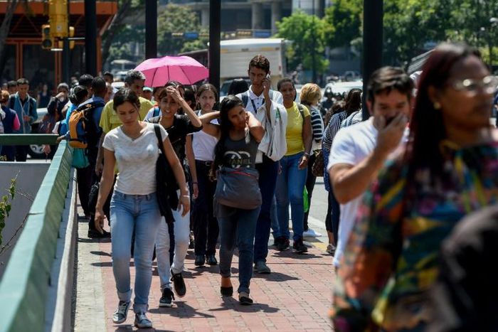 Commuters unable to use the subway due to a partial power cut, flock to the streets in Caracas
