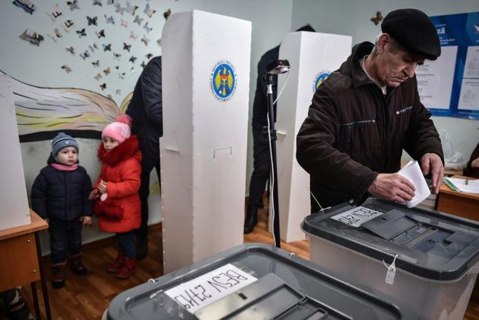 A Moldovan man casts his vote at a polling station in Chisinau on February 24, 2019