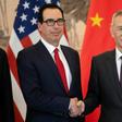 China's Vice Premier Liu He (R) shakes hands with US Treasury Secretary Steven Mnuchin (L) as they pose for a group photo at the Diaoyutai State Guesthouse in Beijing