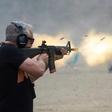 A man fires a machine gun on the main firing line during the Knob Creek Machine Gun Shoot