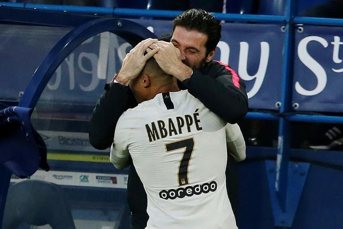 Kylian Mbappe celebrates with Gianluigi Buffon after scoring PSG's winner at Caen on Saturday