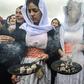 Members of the Yazidi minority take part in a ceremony during the exhumation of a mass grave of victims of the Islamic State group in northern Iraq