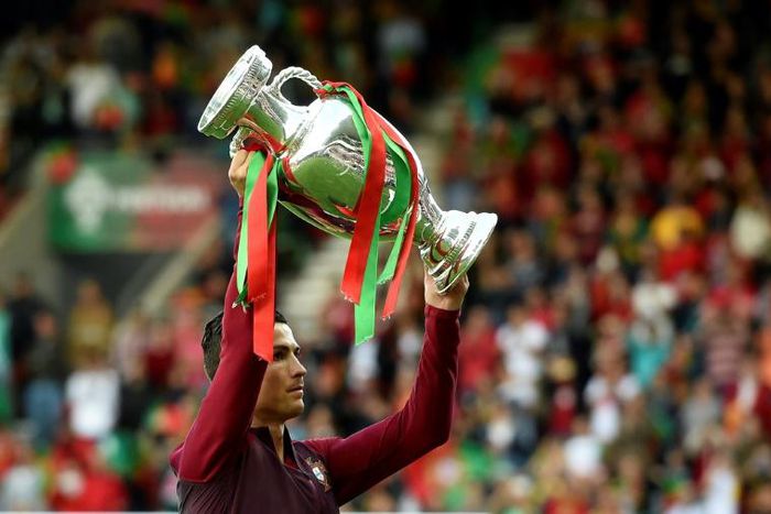 Portugal's forward Cristiano Ronaldo raises the EURO 2016 trophy