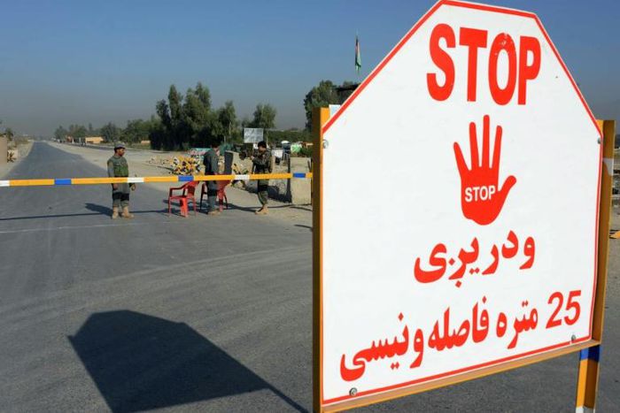 Afghan security personnel stand at a checkpoint outside Jalalabad Airport